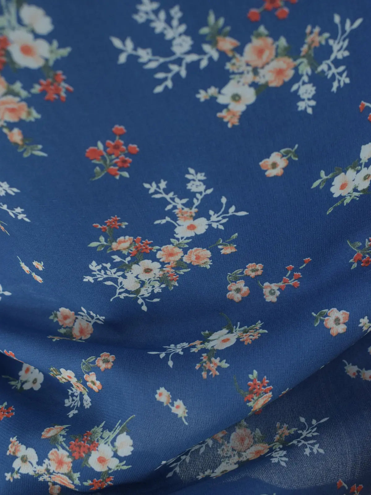 Close-up of dark blue chiffon fabric, floral print