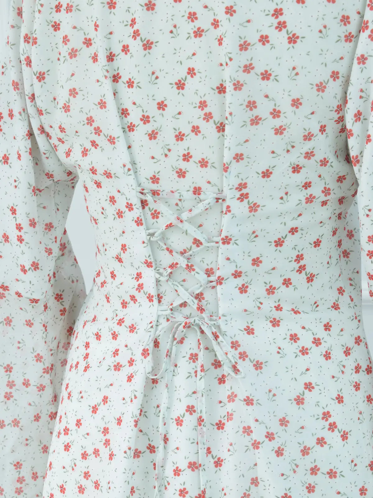 Close-up of corset lace-up back on white floral kurti