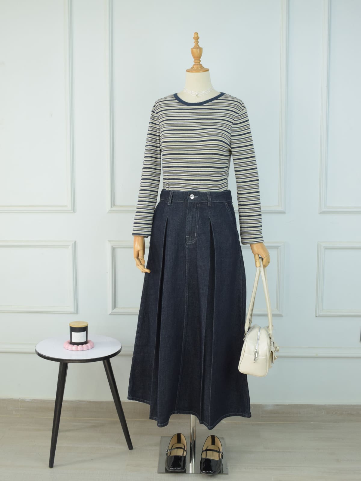 Full length front view of charcoal blue denim maxi skirt styled with striped top, white bag and black loafers on mannequin