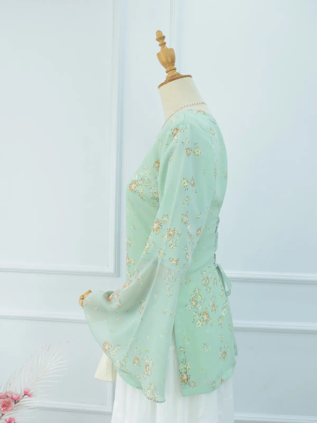 Close-up of V-neck and sheer bell sleeve, green kurti