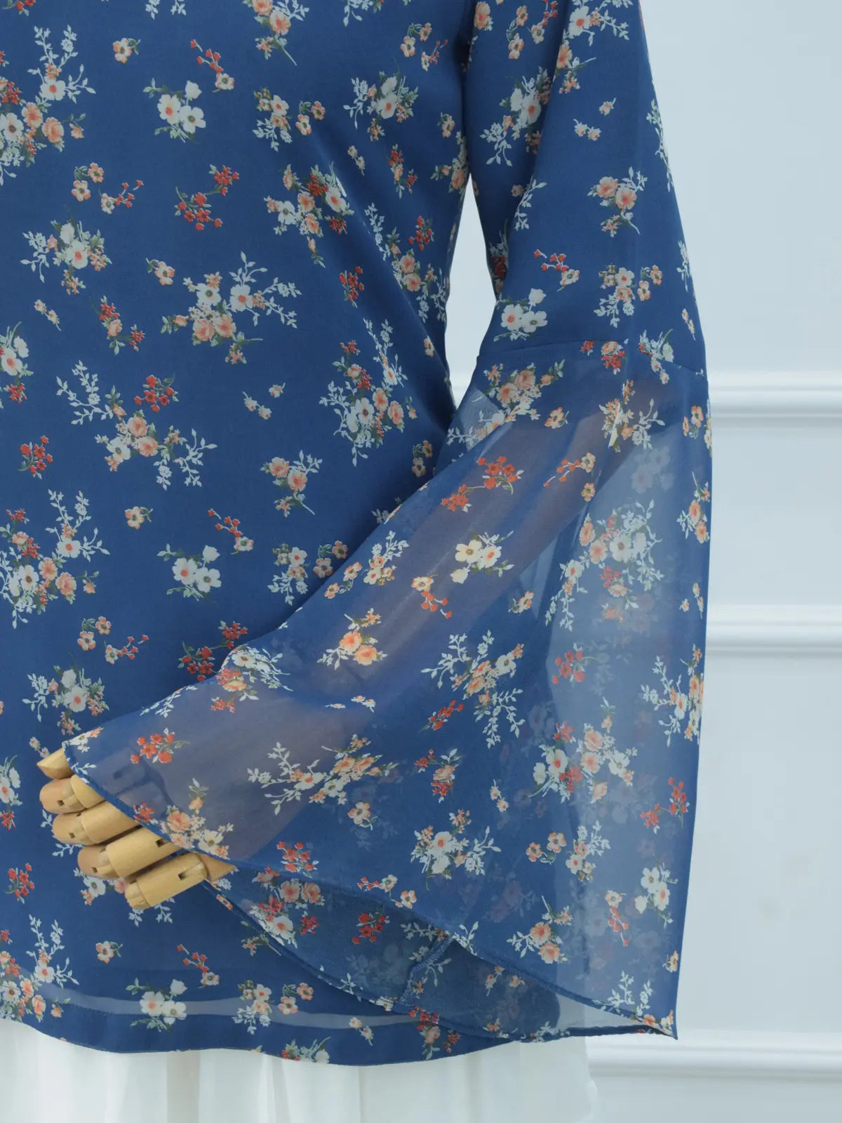 Close-up of sheer bell sleeve, blue floral chiffon kurti