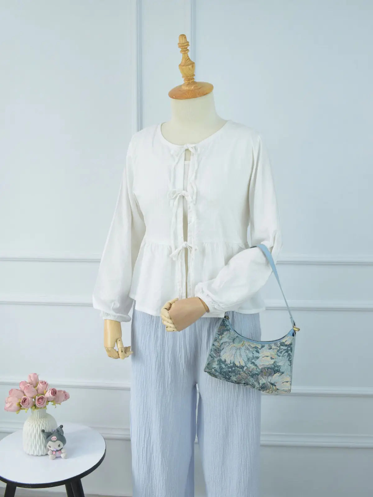 Marina textured blue wide-leg pants full length front view on mannequin – drawstring waist, wide leg silhouette, paired with white ruffle tie top and floral bag
