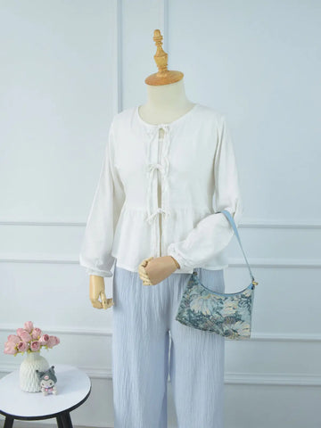 Marina textured blue wide-leg pants full length front view on mannequin – drawstring waist, wide leg silhouette, paired with white ruffle tie top and floral bag