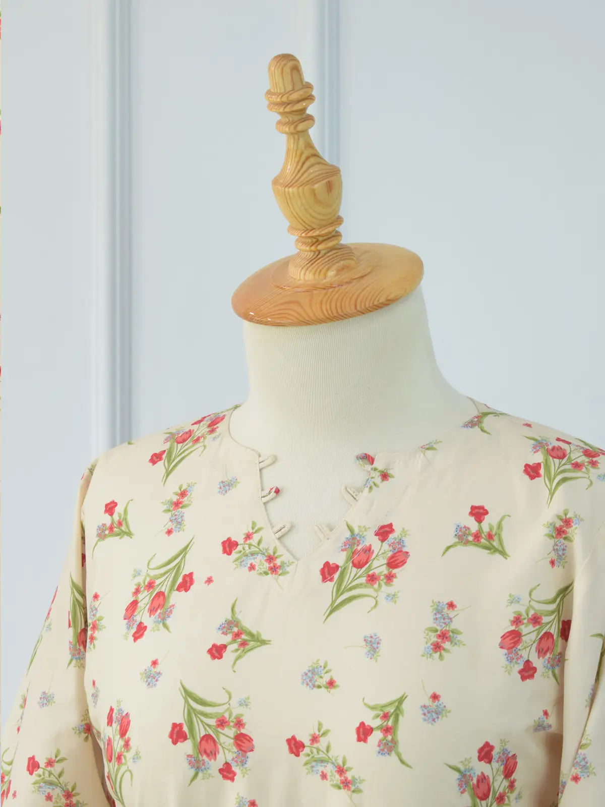 Front angle view of Rosie Bloom beige kurti – red green floral print, wide bell sleeves, structured smart fit silhouette