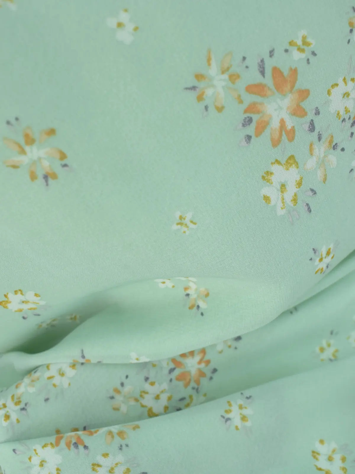 Close-up of pastel green chiffon fabric, floral print