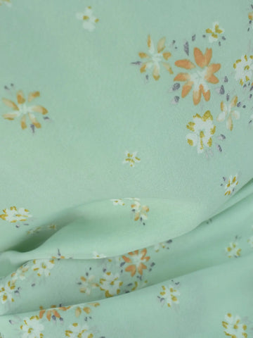 Close-up of pastel green chiffon fabric, floral print