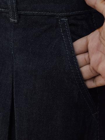 Detail shot of side pocket and belt loop construction on dark denim maxi skirt