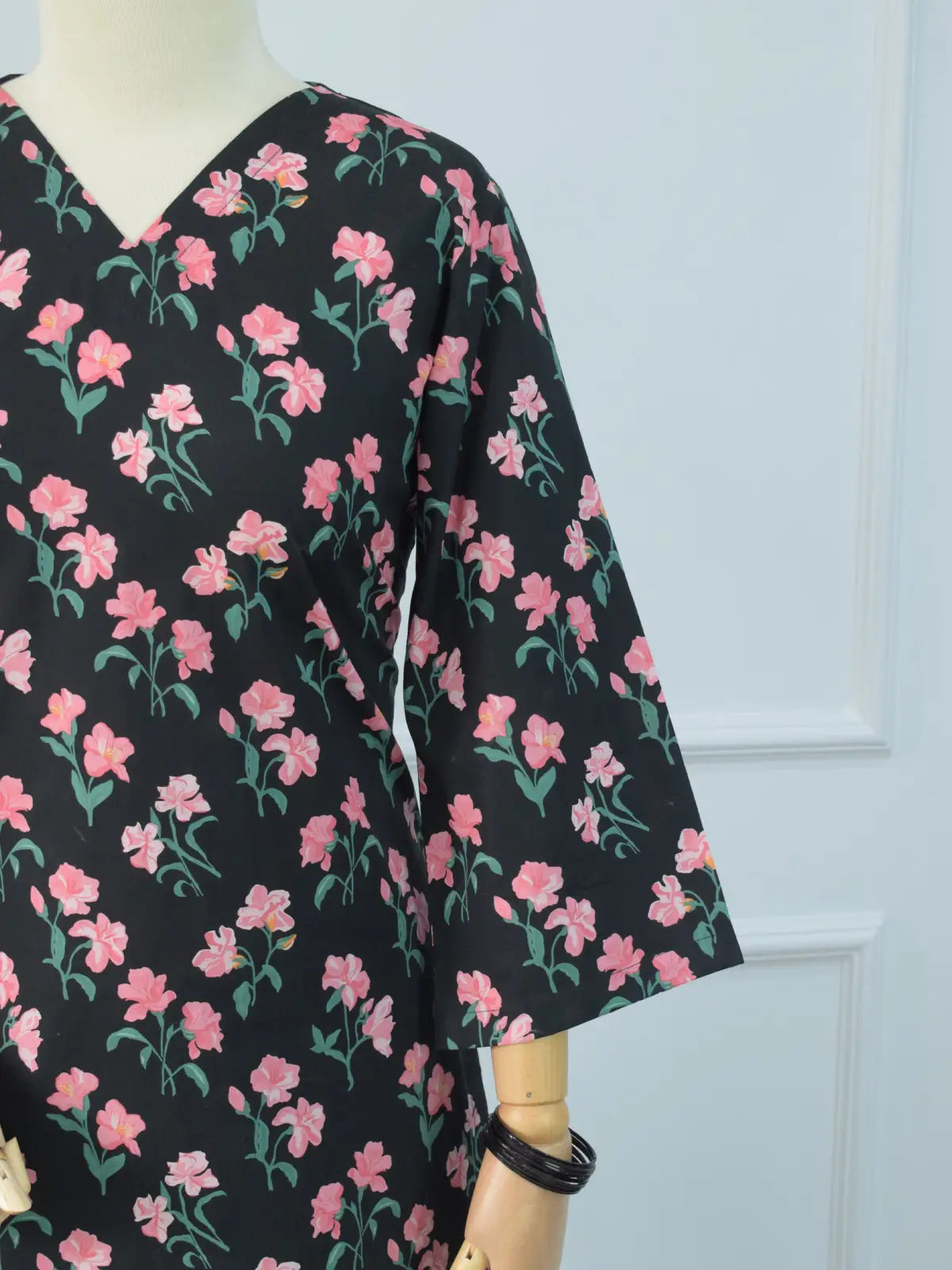 Front angle view of Black Petal black floral kurti – pink floral print, V-neckline, quarter sleeves, structured smart fit silhouette