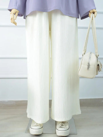 DOVE textured off-white wide-leg pants styled with a lavender top and handbag