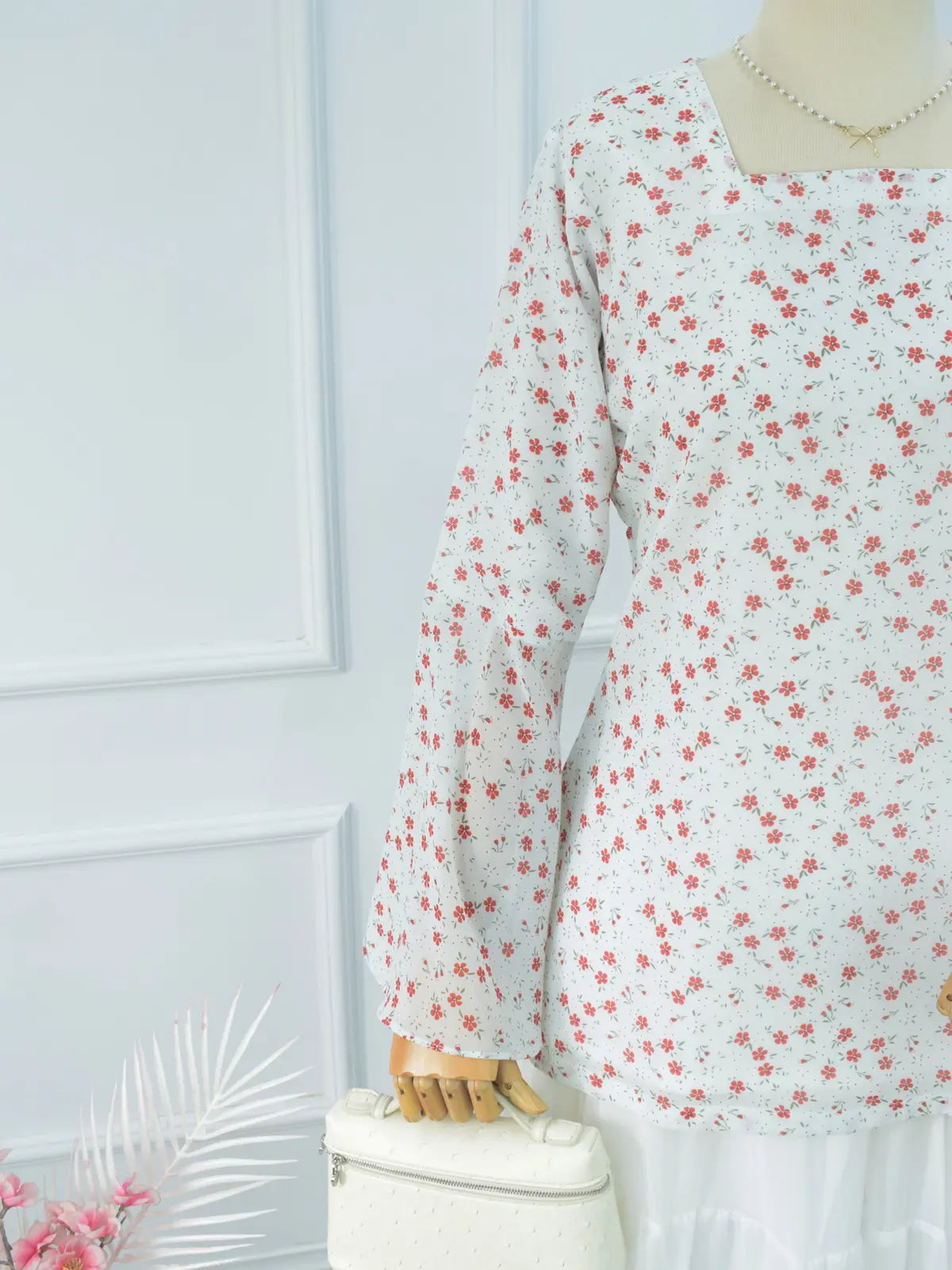 Close-up of V-neck and bell sleeve, white floral kurti