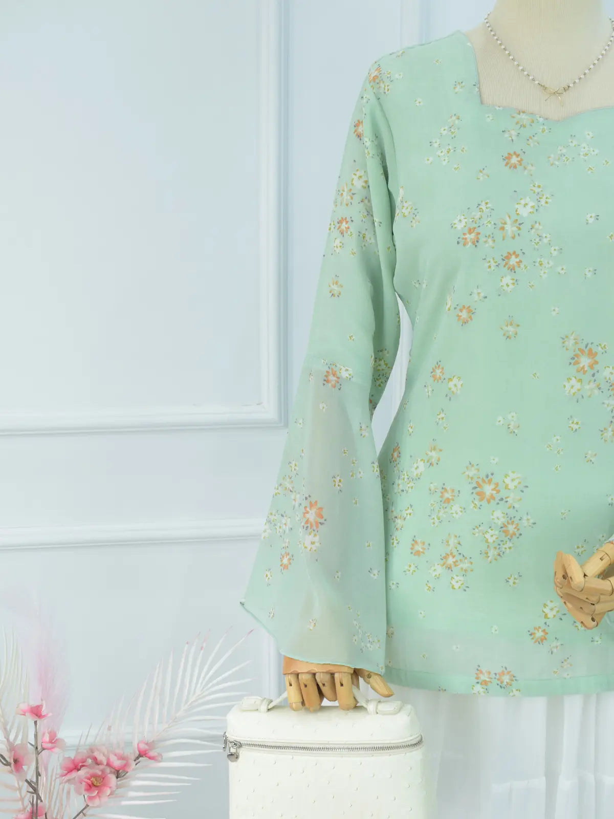 Close-up of sheer bell sleeve, green floral chiffon kurti