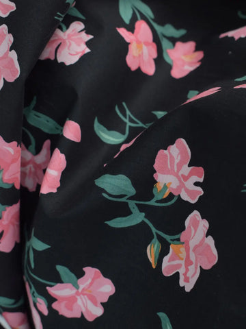 V-neckline detail close-up of Black Petal black kurti – delicate pink floral stems and blooms on black lawn cotton fabric