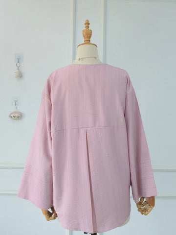 Back view of pink oversized shirt showing pleat detail and relaxed drape on mannequin