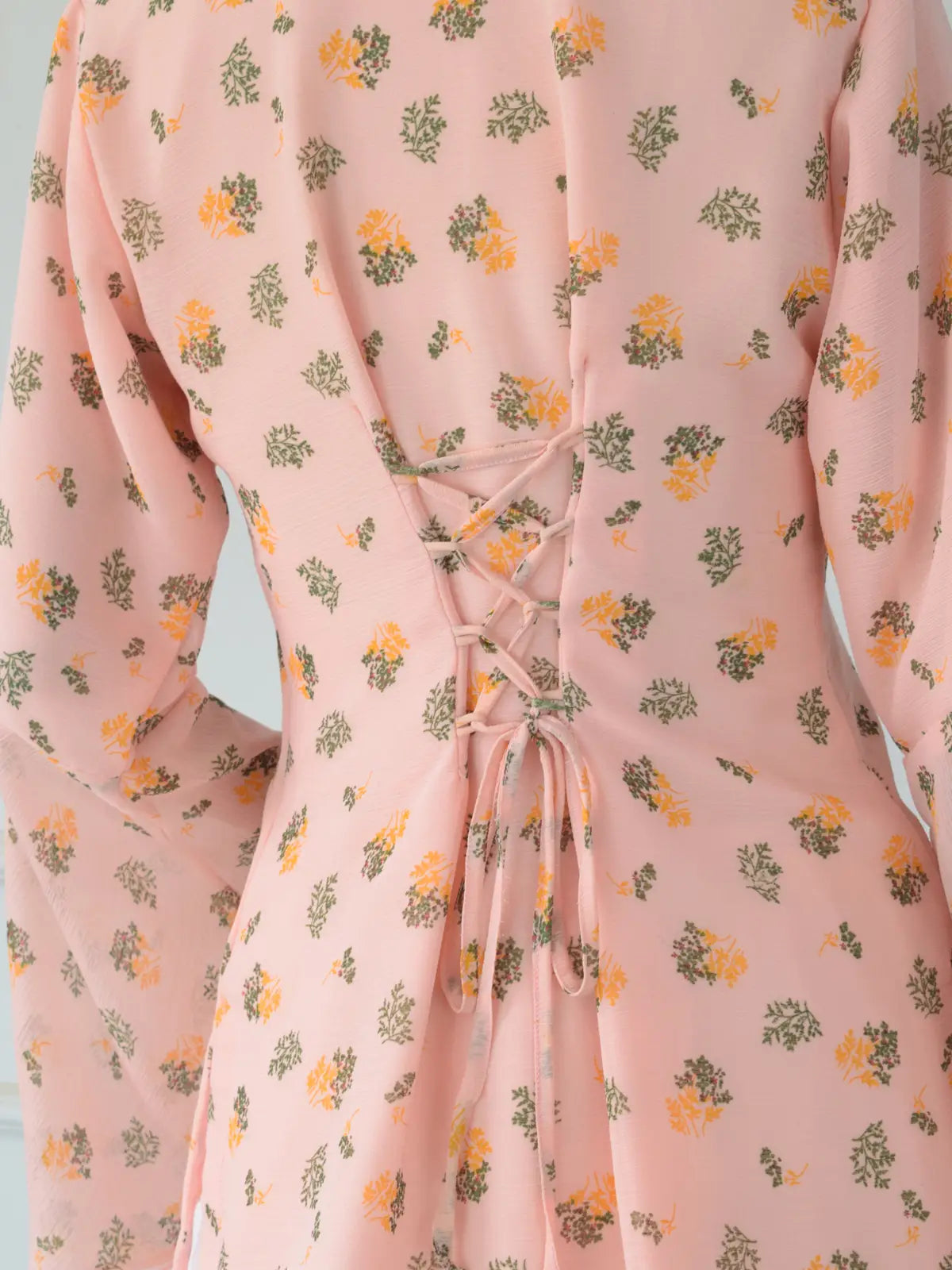 Close-up of corset-style lace-up back with loop eyeletson ROBES Azelia light pink floral kurti