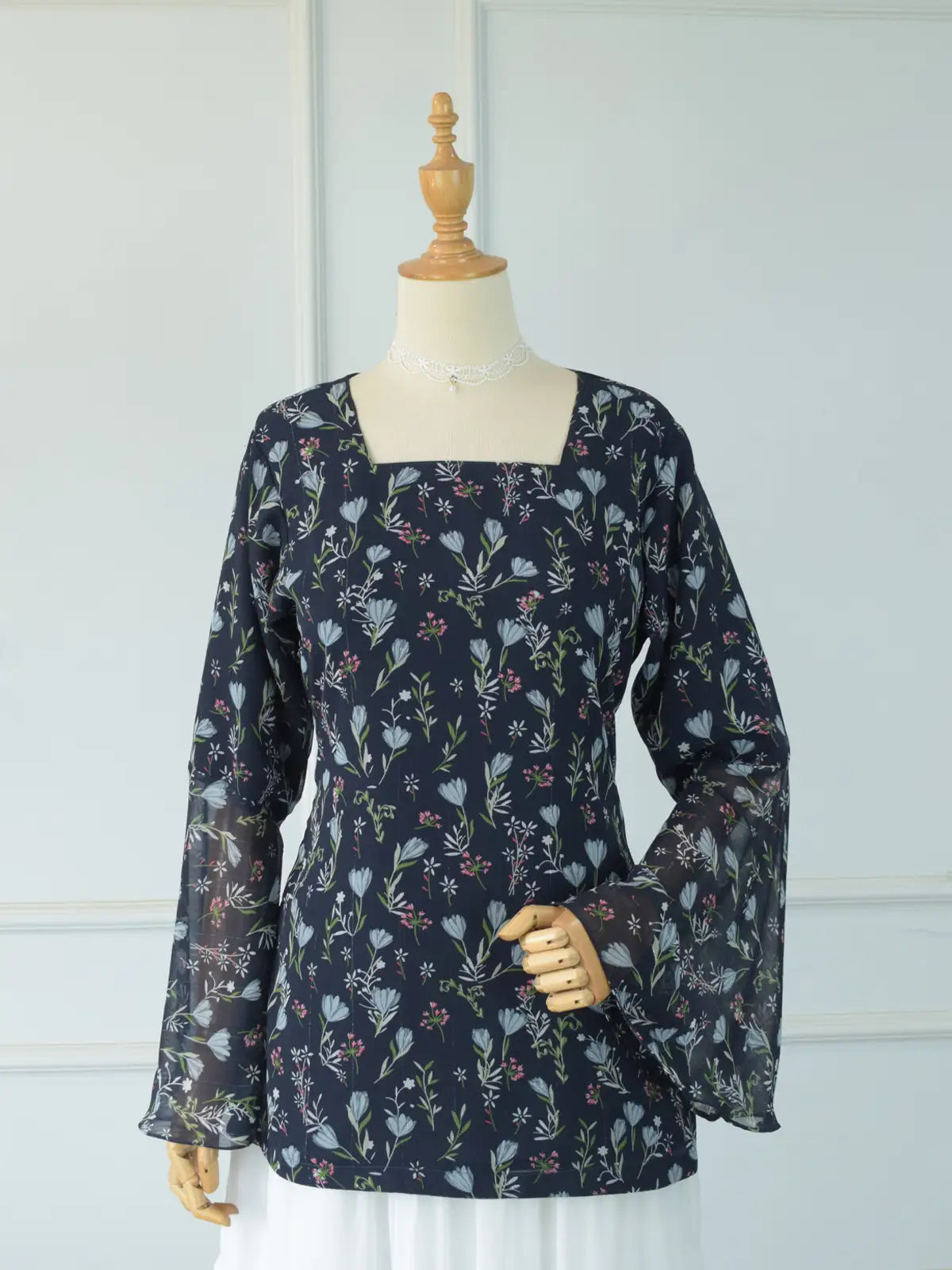 Close-up of sheer chiffon flared bell sleeve on Evalisse navy blue floral kurti