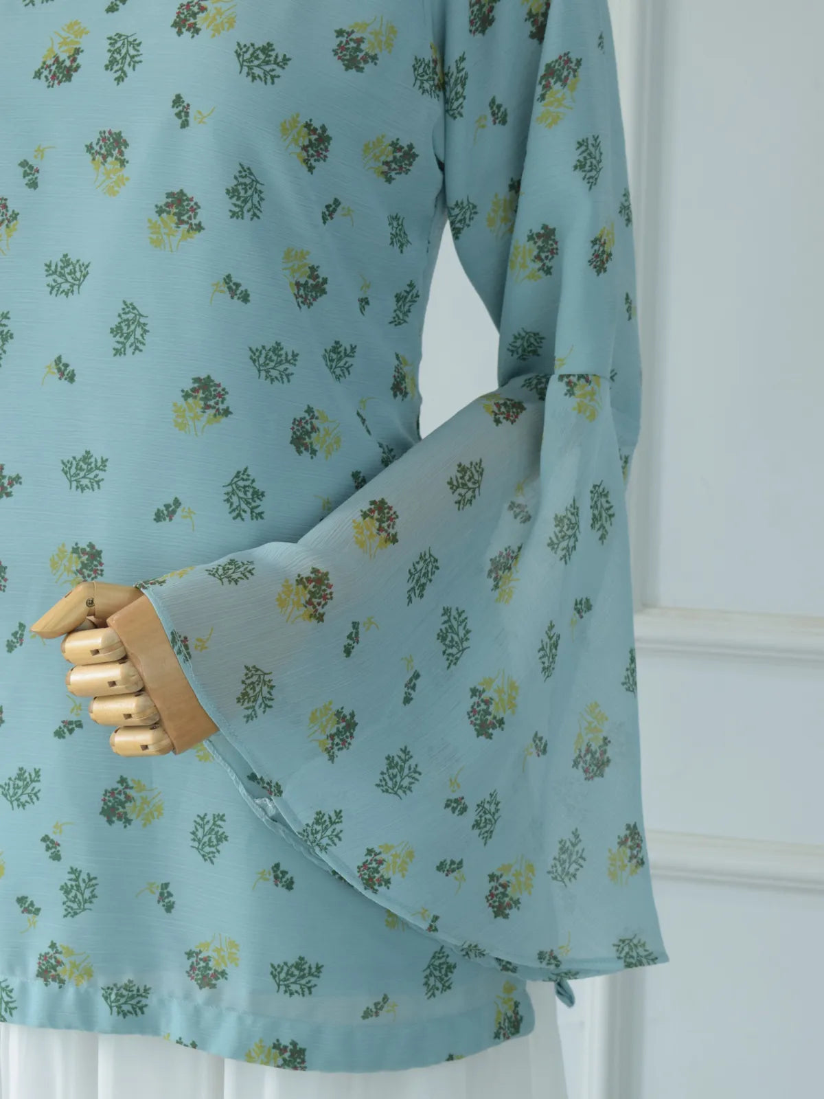 Close-up of sheer chiffon flared bell sleeve on ROBES Cerelia pastel blue floral kurti