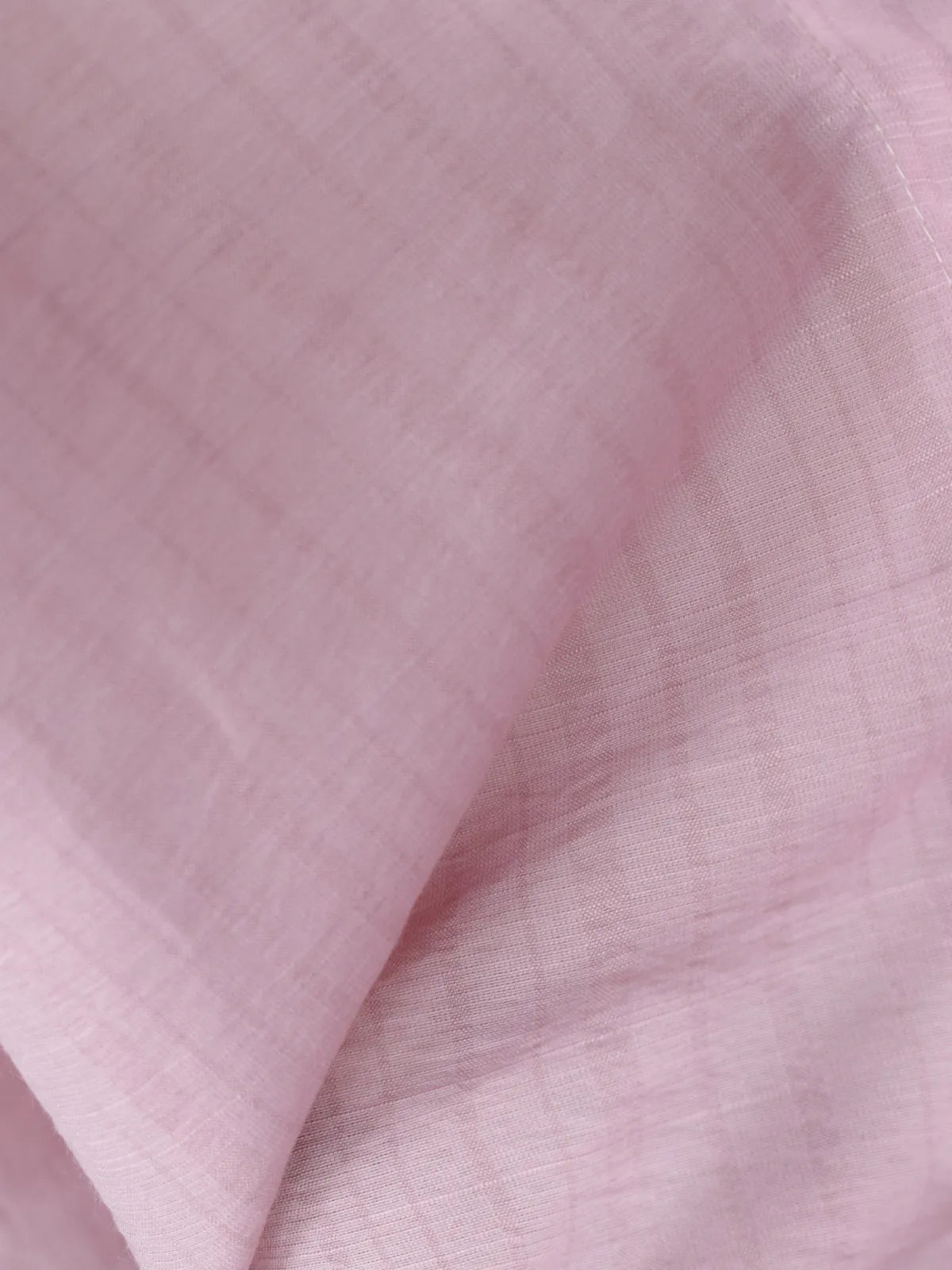 Close-up of soft blush pink cotton fabric with subtle woven vertical stripe texture