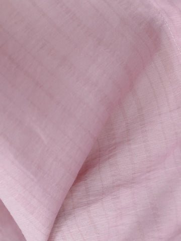 Close-up of soft blush pink cotton fabric with subtle woven vertical stripe texture