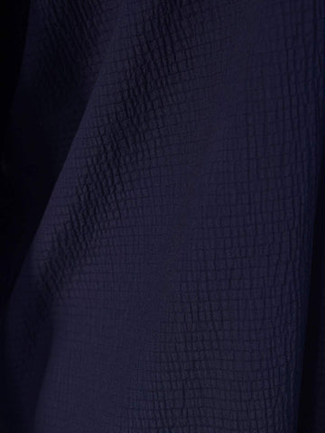 Closeup of textured fabric on Blair navy blue oversized shirt