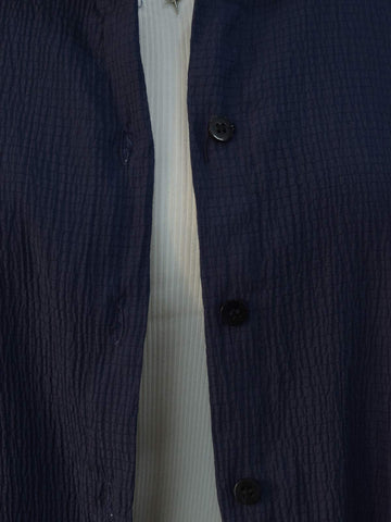 Detail shot of buttons on navy blue textured shirt