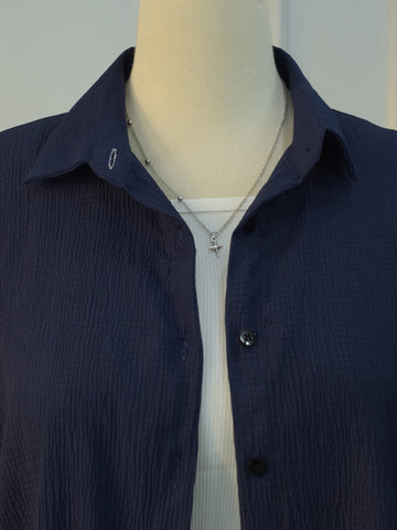 Detail shot of collar on navy blue textured shirt
