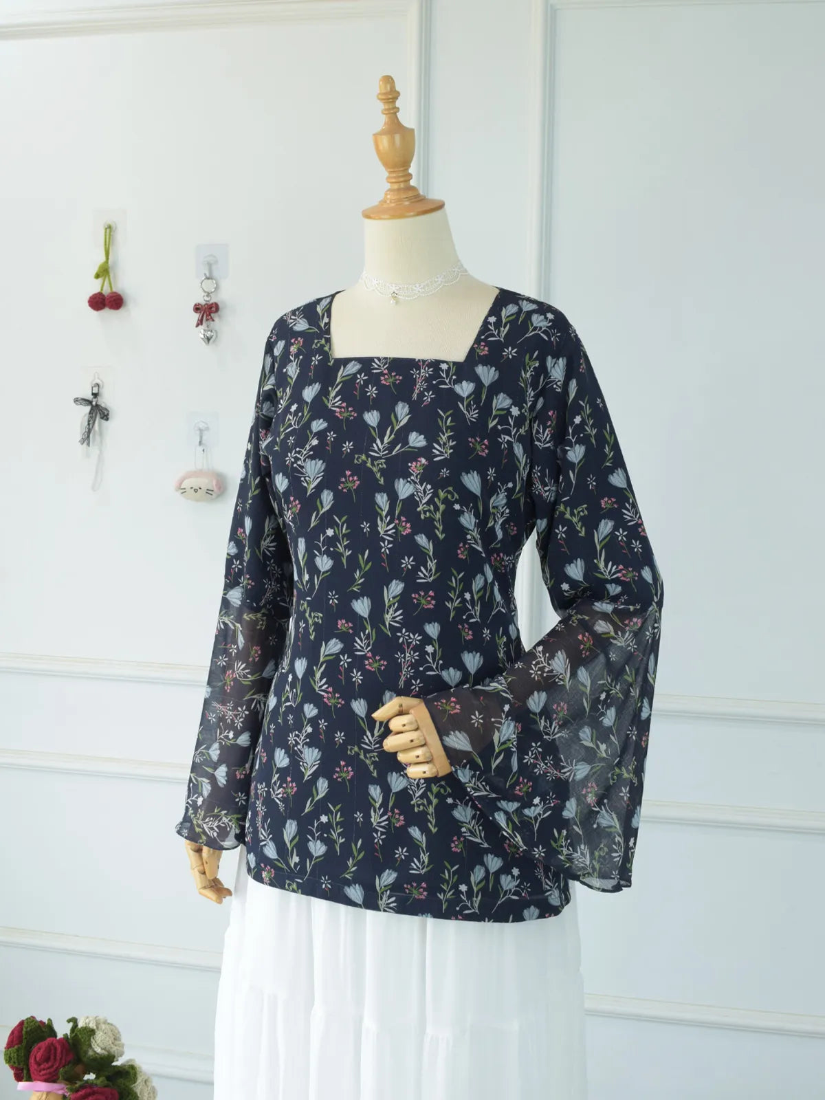 Evalisse navy blue floral fairy kurti paired with white skirt on mannequin — full length front view