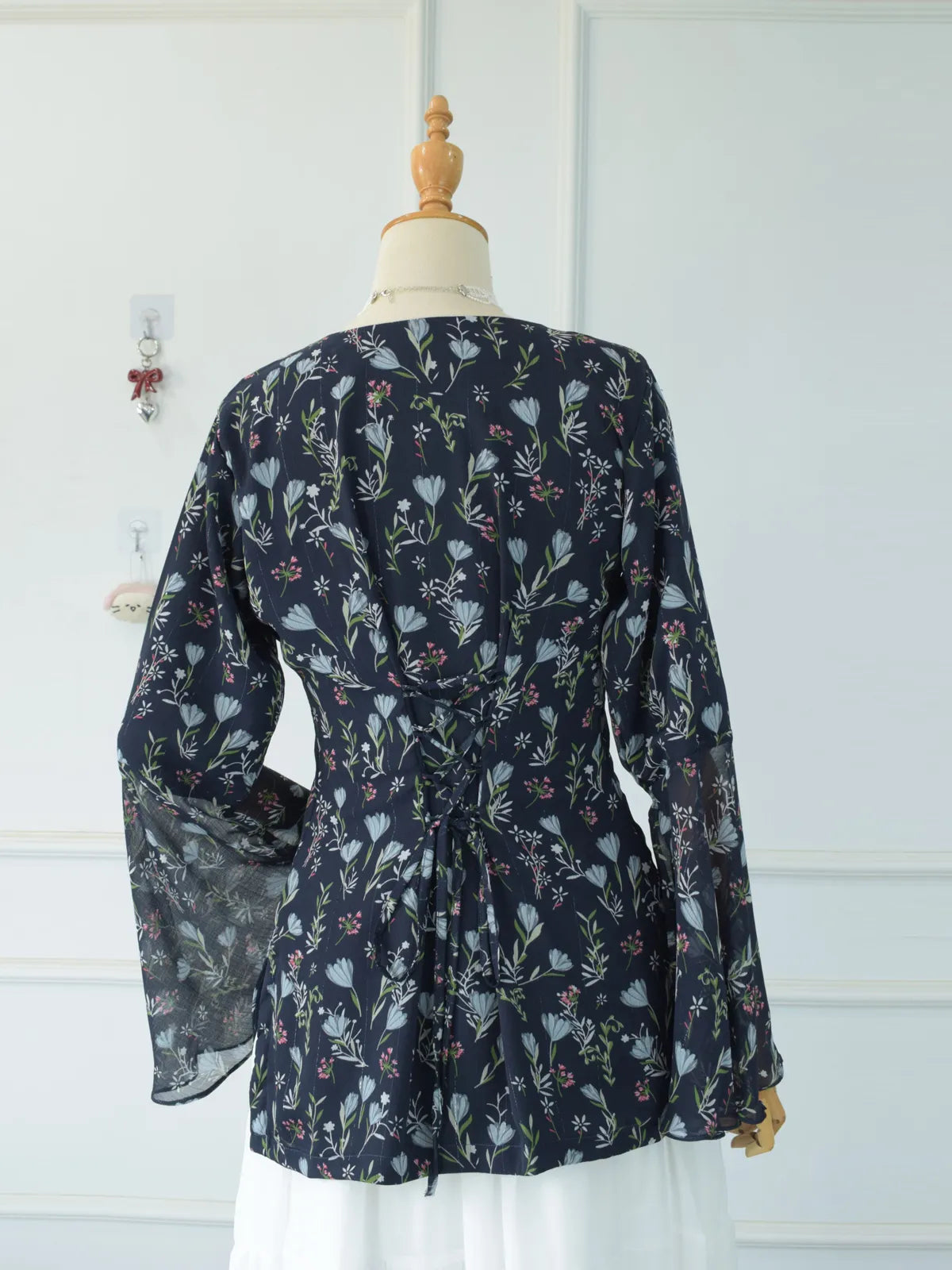 Fabric close-up of Evalisse navy blue chiffon kurti showing blue and pink floral print texture
