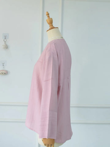 Side profile view of blush pink oversized button-down top on mannequin showing length and silhouette
